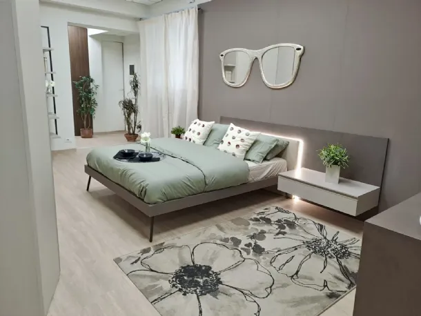 Letto con pannello boiserie a muro e comodini sospesi
